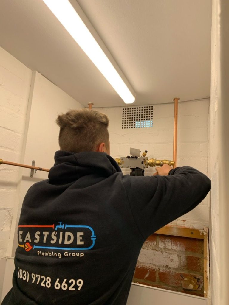 Plumber installing RPZD backflow prevention device